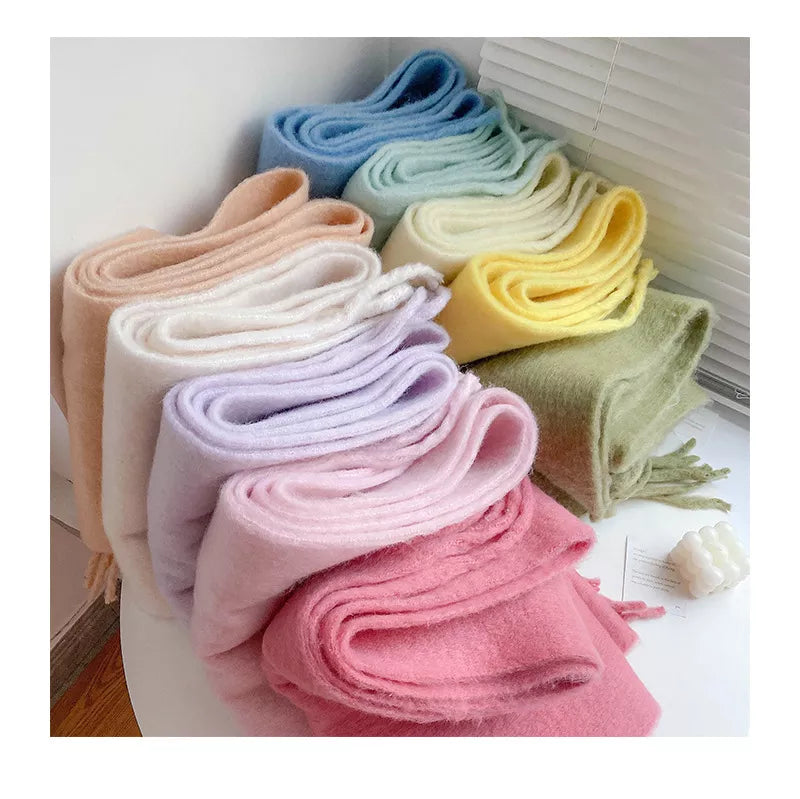 An array of beautiful cashmere scarves folded together on a table