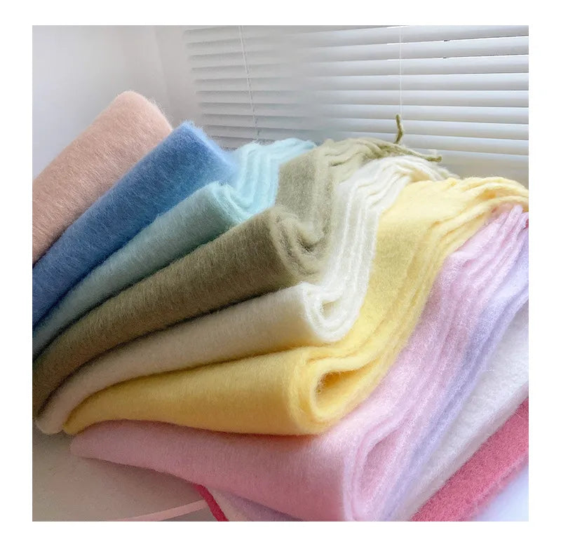 An array of beautiful cashmere scarves folded together on a table