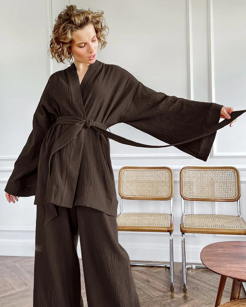 Model wearing brown Ira Kimono and Pants set. Breathable cotton lounge set with matching open-front kimono robe, waist sash, and full-length relaxed-fit pants. Cozy fashion perfect for sleep, loungewear, or resort wear.