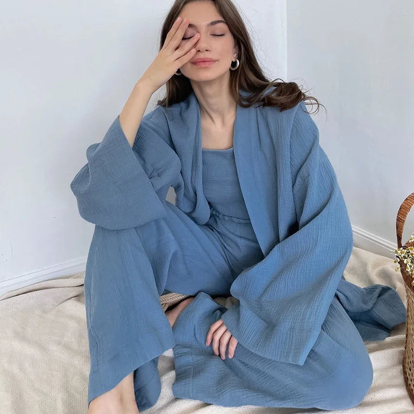 Model wearing blue Ira Kimono and Pants set. Breathable cotton lounge set with matching open-front kimono robe, waist sash, and full-length relaxed-fit pants. Cozy fashion perfect for sleep, loungewear, or resort wear.