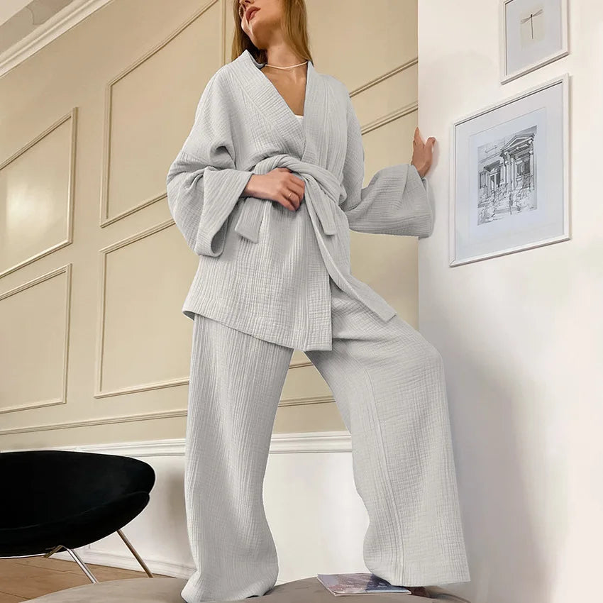 Model wearing light gray Ira Kimono and Pants set. Breathable cotton lounge set with matching open-front kimono robe, waist sash, and full-length relaxed-fit pants. Cozy fashion perfect for sleep, loungewear, or resort wear.