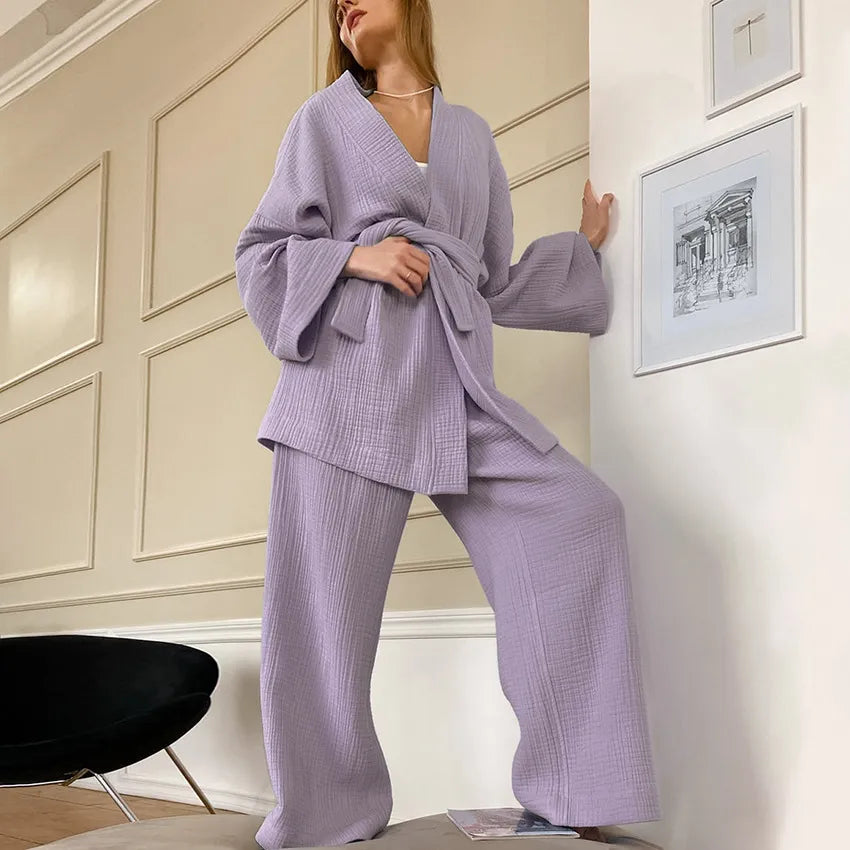 Model wearing lavender gray Ira Kimono and Pants set. Breathable cotton lounge set with matching open-front kimono robe, waist sash, and full-length relaxed-fit pants. Cozy fashion perfect for sleep, loungewear, or resort wear.