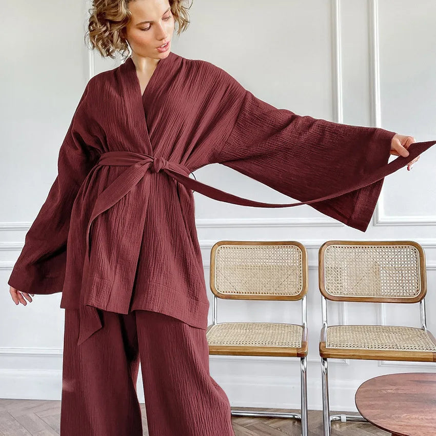 Model wearing brick red Ira Kimono and Pants set. Breathable cotton lounge set with matching open-front kimono robe, waist sash, and full-length relaxed-fit pants. Cozy fashion perfect for sleep, loungewear, or resort wear.
