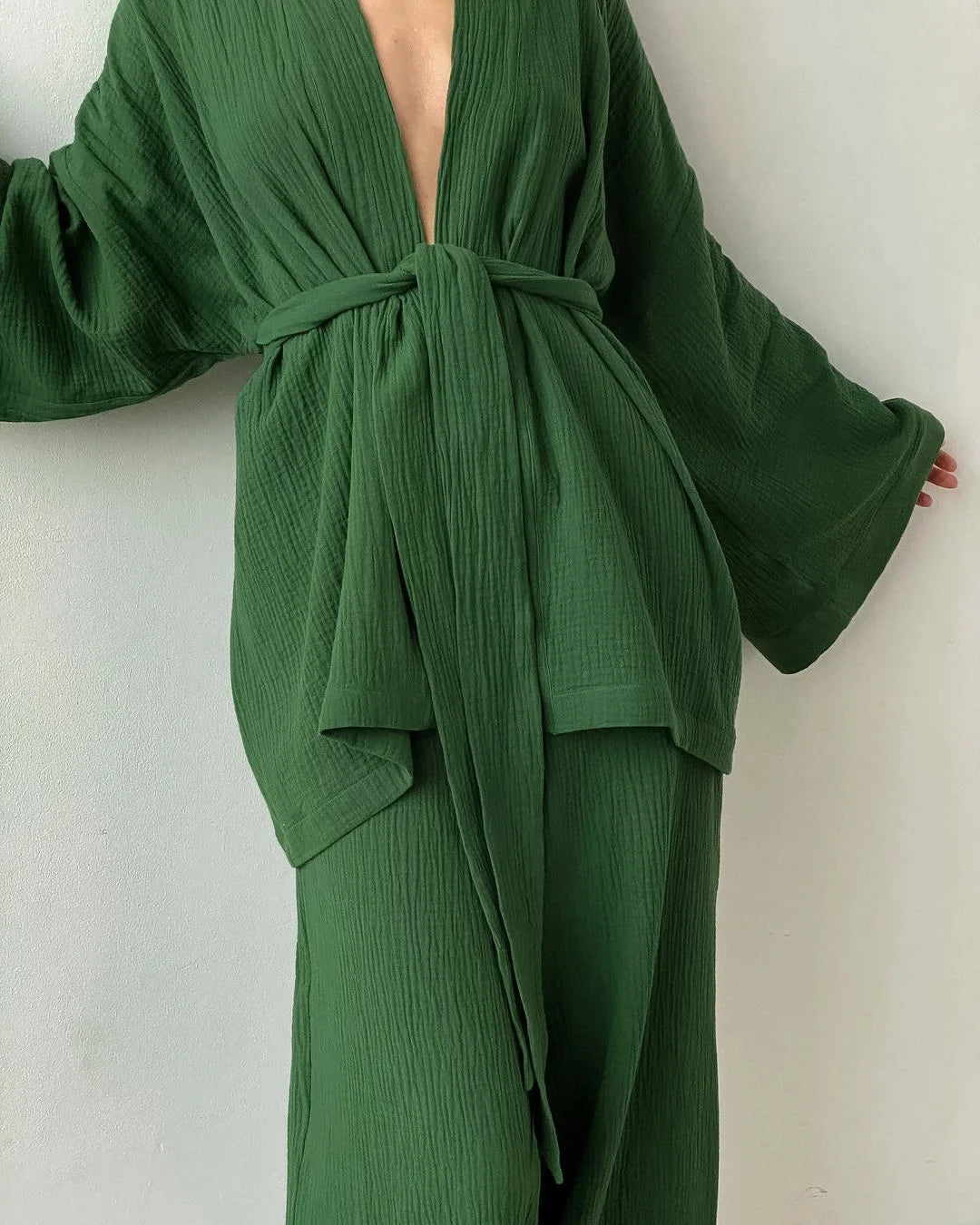 Model wearing green Ira Kimono and Pants set. Breathable cotton lounge set with matching open-front kimono robe, waist sash, and full-length relaxed-fit pants. Cozy fashion perfect for sleep, loungewear, or resort wear.