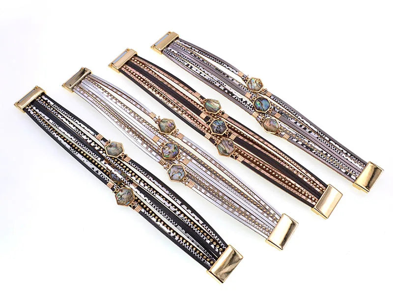 Four Abalone Bracelets laid flat in black, grey, brown and silver