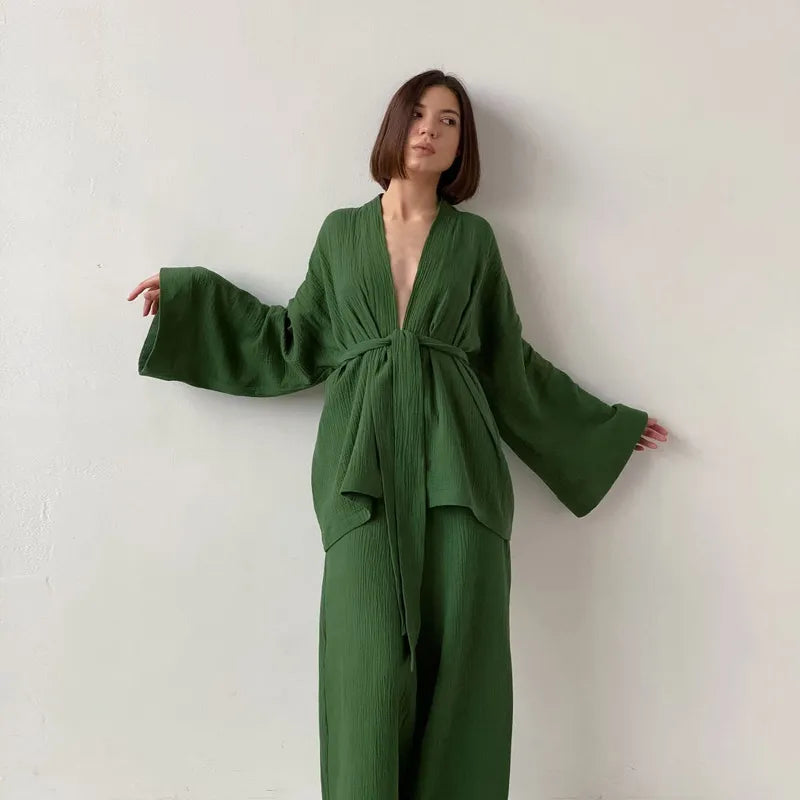 Model wearing green Ira Kimono and Pants set. Breathable cotton lounge set with matching open-front kimono robe, waist sash, and full-length relaxed-fit pants. Cozy fashion perfect for sleep, loungewear, or resort wear.