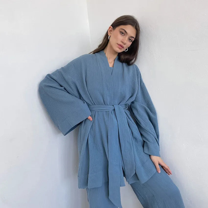 Model wearing blue Ira Kimono and Pants set. Breathable cotton lounge set with matching open-front kimono robe, waist sash, and full-length relaxed-fit pants. Cozy fashion perfect for sleep, loungewear, or resort wear.