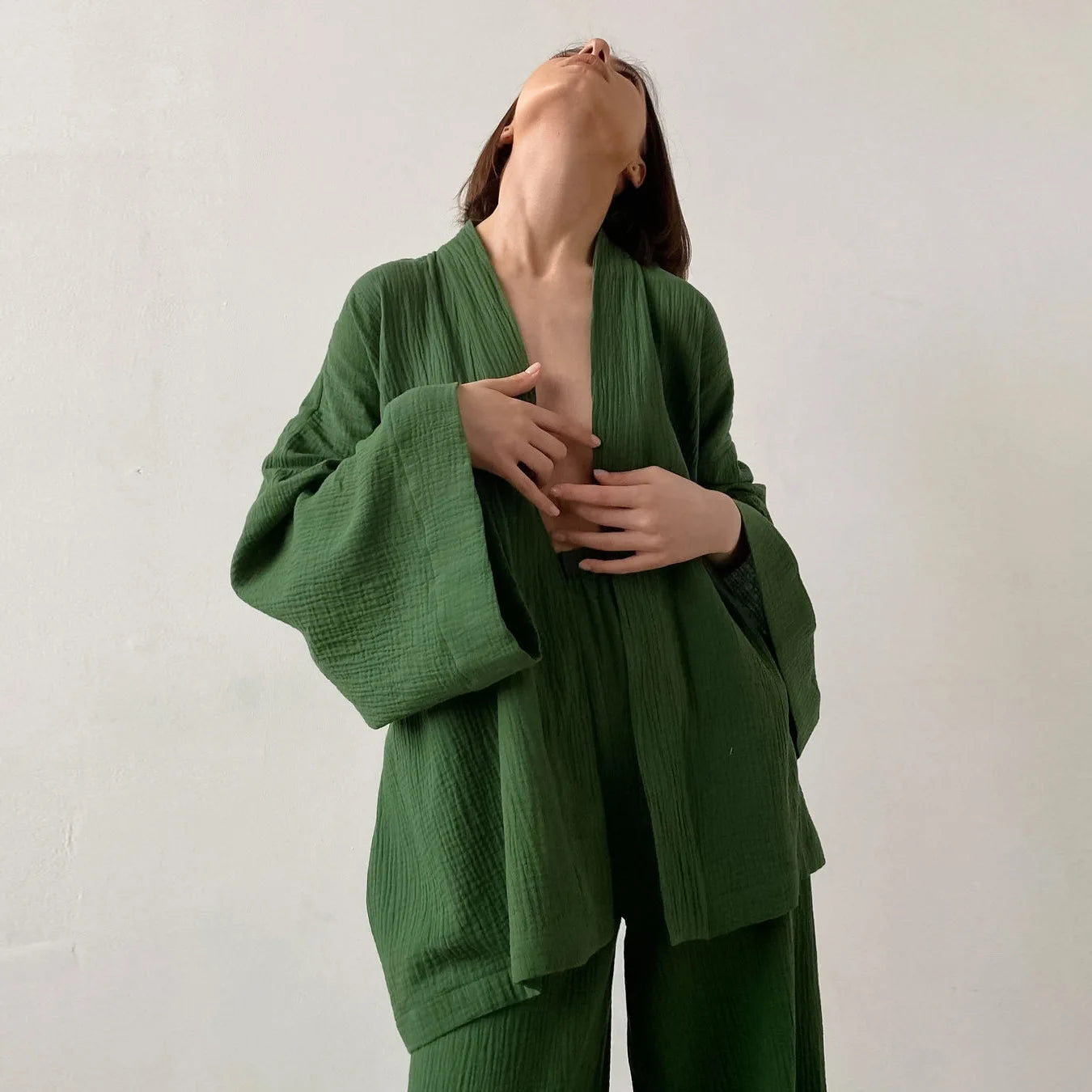 Model wearing green Ira Kimono and Pants set. Breathable cotton lounge set with matching open-front kimono robe, waist sash, and full-length relaxed-fit pants. Cozy fashion perfect for sleep, loungewear, or resort wear.