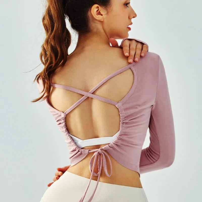 Eden Seamless Cross Back Top from Shop the Kei - pink color option back view of soft and breathable dancer inspired long sleeve top with adjustable back straps that tie at the hem.