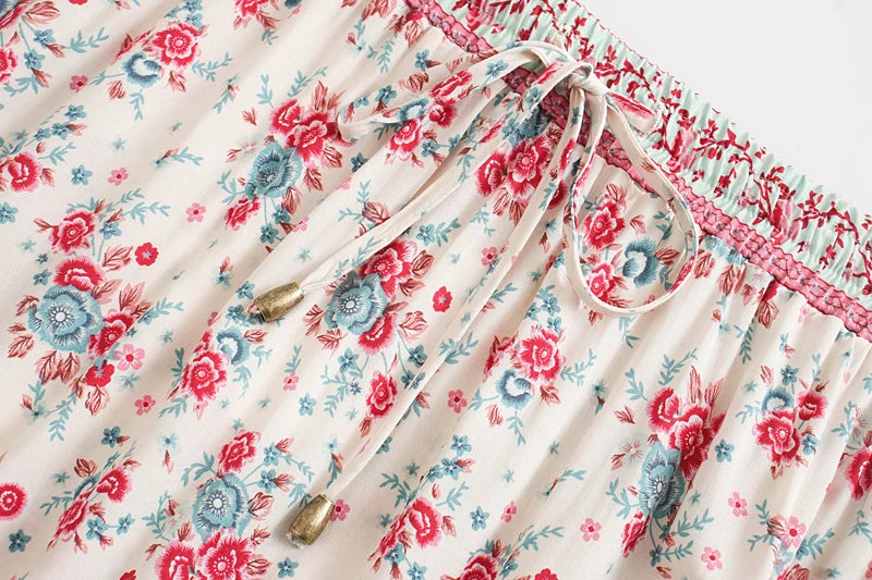 Birdie Summer Midi Skirt from Shop The Kei - red skirt closeup detail of ivory color stretch waistband, beaded waist tie, floral print pattern, and natural fiber textile texture