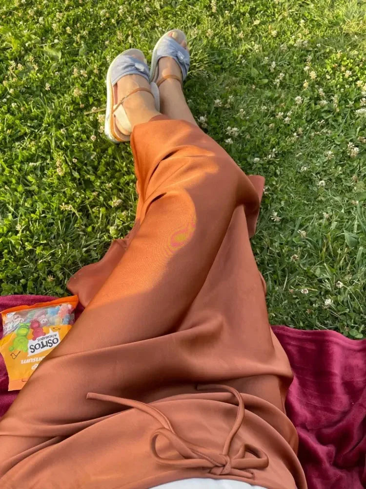 Bela Satin Maxi Skirt from Shop the Kei - black bias fitting skirt. Wear it on a picnic blanket with sandals