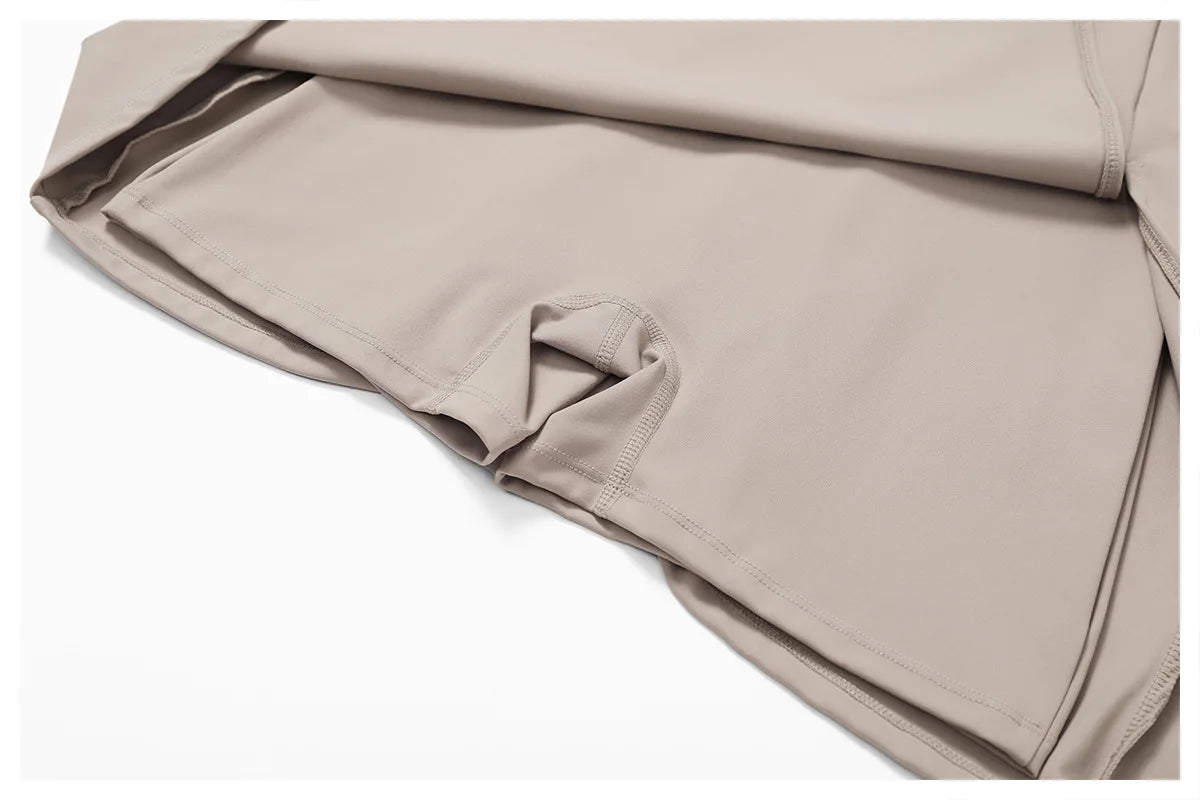 Close view of the Bree Yoga Dress in dark linen color. Highlights the shorts construction and smooth textile texture