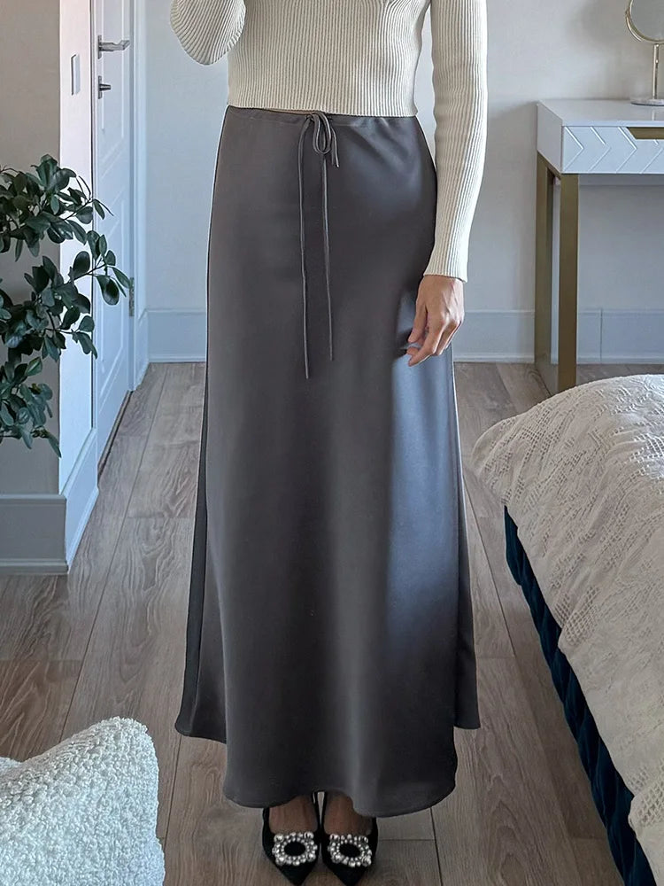 Bela Satin Maxi Skirt from Shop the Kei - gray bias fitting skirt looks more formal with sparkly heels.