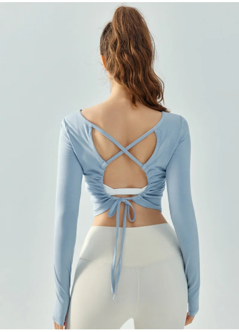 Eden Seamless Cross Back Top from Shop the Kei - back view of soft and breathable dancer inspired long sleeve top with adjustable back straps that tie at the hem. Pairs well with yoga pants.