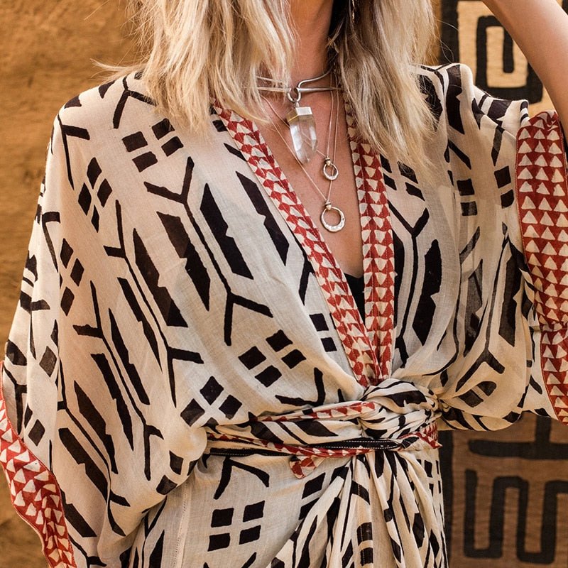 Close up of model wearing Ethola Kimono from Shop The Kei Swim collection. Image depicts an earthy textile texture and geometric print fabrication. Model pairs the kimono with sterling silver boho jewelry