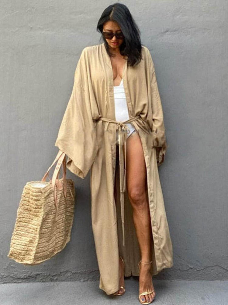 Front view of model wearing the Sand Sole Kimono from Shop the Kei with a white one piece swimsuit, straw tote, and gold heels. A Bohemian-style ankle-length beach cover-up kimono with wide sleeves and matching waist sash, perfect for vacation, poolside, or post-swim lounging.