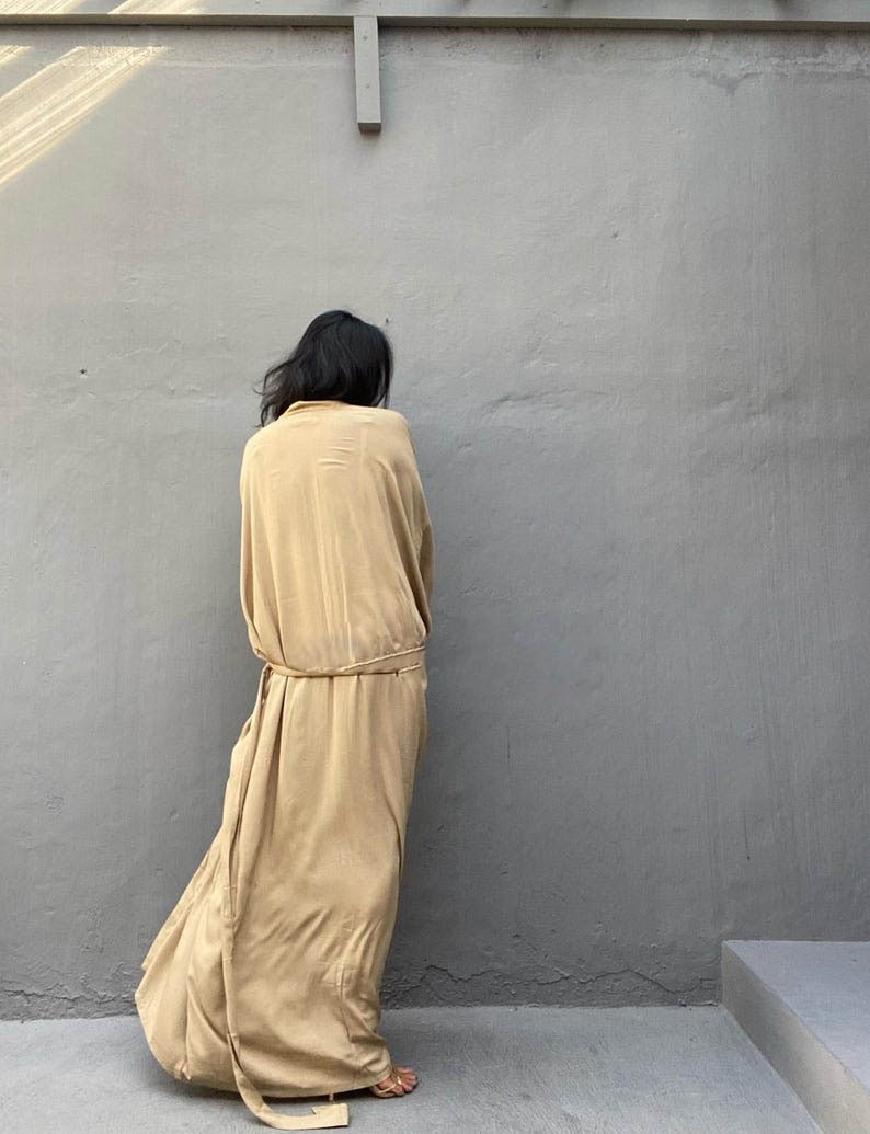 Back view of model wearing the Sand Sole Kimono from Shop the Kei with gold heels. A Bohemian-style ankle-length beach cover-up kimono with wide sleeves and matching waist sash, perfect for vacation, poolside, or post-swim lounging.