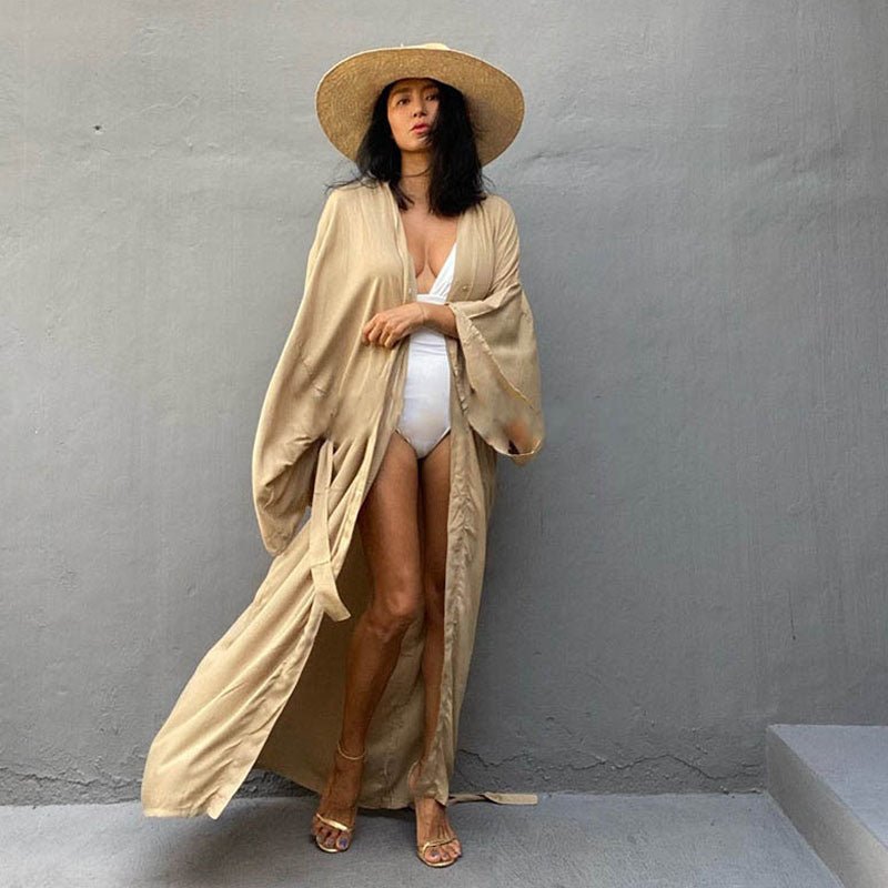 Front view of model wearing the Sand Sole Kimono from Shop the Kei with a white one piece swimsuit, straw hat, and gold heels. A Bohemian-style ankle-length beach cover-up kimono with wide sleeves and matching waist sash, perfect for vacation, poolside, or post-swim lounging.