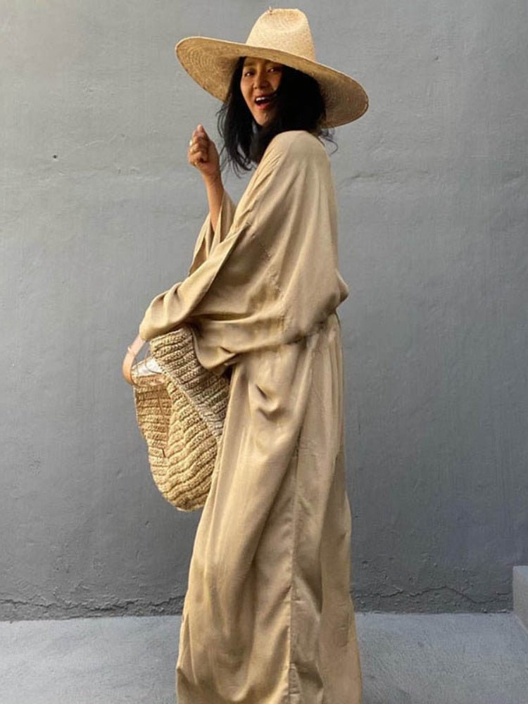 Front view of model wearing the Sand Sole Kimono from Shop the Kei with a straw tote, and sun hat. A Bohemian-style ankle-length beach cover-up kimono with wide sleeves and matching waist sash, perfect for vacation, poolside, or post-swim lounging.