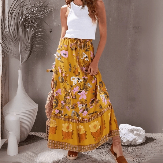 Poppy Summer Maxi Skirt from Shop The Kei - flowing golden yellow floral maxi skirt with elastic waistband and ruffled hem, made of natural fibers. Pairs well with white lace tank tops and tan sandals