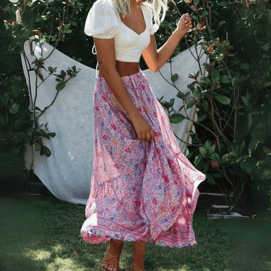 Amelie Boho Maxi Skirt from Shop The Kei - flowing pink floral maxi skirt with elastic waistband and ruffled hem, made of natural fibers. Pairs well with white lace tops and puff sleeves.