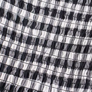 Close-up detail of the Pixi Dress showing black and white gingham fabric with shirred bodice