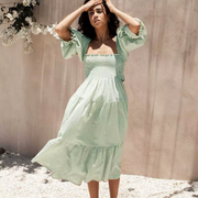 Front view of the Pixi Dress in mint green gingham pattern showcasing square neckline, voluminous puff sleeves, smocked bodice, and flowing tiered midi skirt. Dress photographed in bright sunlight against a neutral backdrop.
