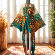 Colorful patterned kimono on a mannequin against a bright window with plants.
