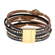 Multistrand leather bracelet with gold accents on a white background