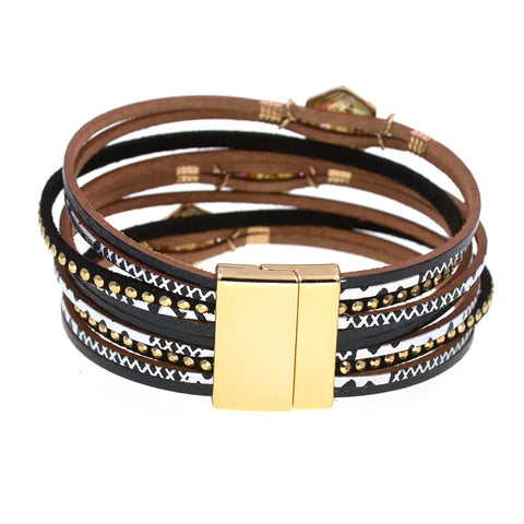 Multistrand leather bracelet with gold accents on a white background