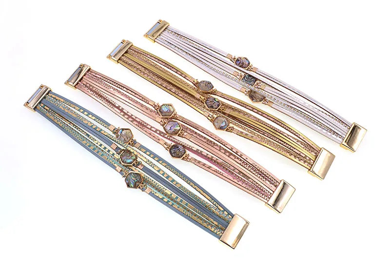 Four Abalone Bracelets laid flat in teal, rose gold, gold and silver