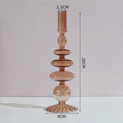 Roma Glass candlestick holder by Shop the Kei home treasure collection in clear orange. Roma Glass candlestick holder by Shop the Kei home treasure collection in clear brown. Stacked 1-drop, 1-saucer, 2-disk, bubble with scalloped slope base modern-style blown glass candlestick holder dimensions 2.5cm X 28cm X 9cm