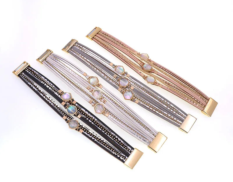 Four Abalone Bracelets laid flat in black, grey, silver and rose gold