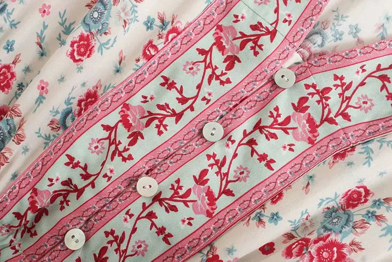 Birdie Summer Midi Dress from Shop the Kei - close up of the button v neckline, flower print reds, pinks, and blues in soft natural textile