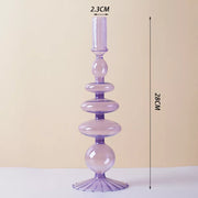 Roma Glass candlestick holder by Shop the Kei home treasure collection in clear purple. Roma Glass candlestick holder by Shop the Kei home treasure collection in clear purple. Stacked 1-drop, 1-saucer, 2-disk, bubble with scalloped slope base modern-style blown glass candlestick holder dimensions 2.5cm X 28cm X 9cm