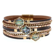 Multistrand bracelet with hexagonal gemstones and gold accents on a white background