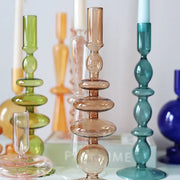 Roma Glass candlestick holders by Shop the Kei home treasure collection in various clear colors; green, blue, brown, and yellow. Handmade modern-style colored glass candlestick holder, tall and elegant, perfect for home décor. Available in multiple unique designs 
