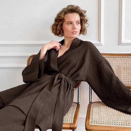 Model lounging in brown Ira Kimono and Pants set. Breathable cotton lounge set with matching open-front kimono robe, waist sash, and full-length relaxed-fit pants. Cozy fashion perfect for sleep, loungewear, or resort wear.