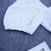 White Lylah Bikini from ShoptheKei.com.  Close up view of the puffy short sleeve gathering construction and smooth white fabrication