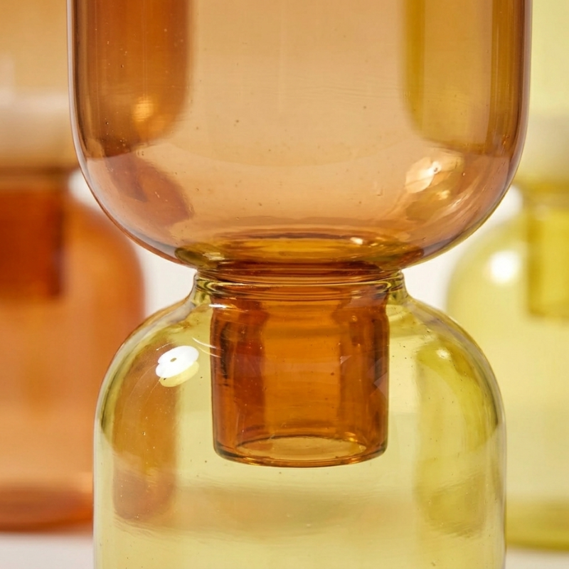 Close-up of a Brown Pilla Candle Holder Top's stem nesting into a Yellow Bottom's neck, showing how the two pieces stack together.
