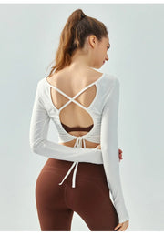 Eden Seamless Cross Back Top from Shop the Kei - back view of soft and breathable dancer inspired long sleeve top with adjustable back straps that tie at the hem. Pairs well with yoga pants.