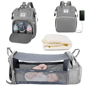 Gray baby diaper backpack shown in multiple views: with bottle storage compartment open, with USB charging port, folded mattress insert, and fully expanded as bassinet with mesh sides containing a baby. Lotus 3-in-1 bassinet diaper bag travel system with partial canopy