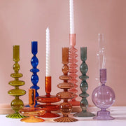 Roma Glass candlestick holders by Shop the Kei home treasure collection in various clear colors; green, blue, purple, and pink. Handmade modern-style colored glass candlestick holder, tall and elegant, perfect for home décor. Available in multiple unique designs