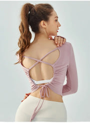 Eden Seamless Cross Back Top from Shop the Kei - back view of soft and breathable dancer inspired long sleeve top with adjustable back straps that tie at the hem. Pairs well with yoga pants.