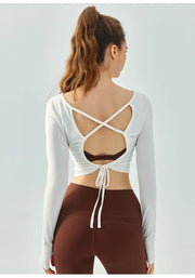Eden Seamless Cross Back Top from Shop the Kei - back view of soft and breathable dancer inspired long sleeve top with adjustable back straps that tie at the hem. Pairs well with yoga pants.