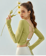 Eden Seamless Cross Back Top from Shop the Kei - back view of soft and breathable dancer inspired long sleeve top with adjustable back straps that tie at the hem. Pairs well with yoga pants.