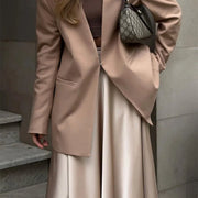 Amber Satin Maxi Skirt from Shop the Kei - flowing satin maxi skirt with high waist and flare hem. Completes a professional look with a blazer 