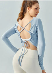 Eden Seamless Cross Back Top from Shop the Kei - back view of soft and breathable dancer inspired long sleeve top with adjustable back straps that tie at the hem. Pairs well with yoga pants.