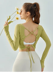 Eden Seamless Cross Back Top from Shop the Kei - back view of soft and breathable dancer inspired long sleeve top with adjustable back straps that tie at the hem. Pairs well with yoga pants.