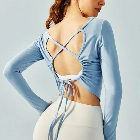 Eden Seamless Cross Back Top from Shop the Kei - light blue color option back view of soft and breathable dancer inspired long sleeve top with adjustable back straps that tie at the hem.